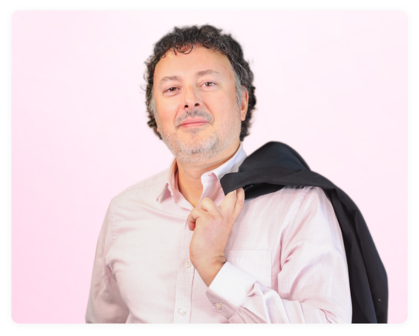 Neal Sabourin, the COO of CPLF smiling in front of a soft pink background.